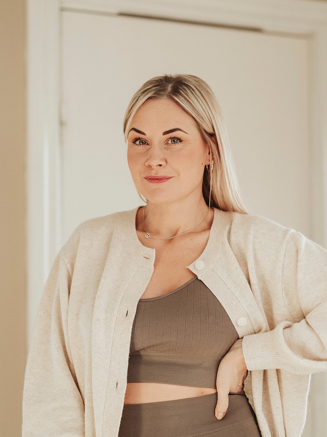 Woman wearing a cardigan and crop top.