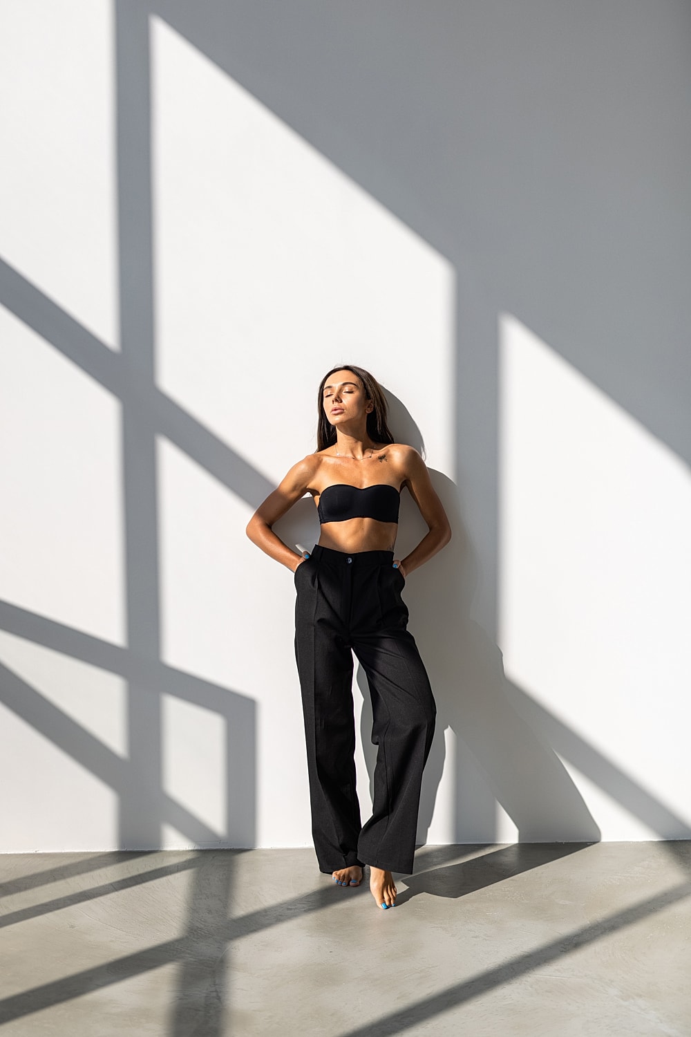 Model posing against a stark white backdrop.